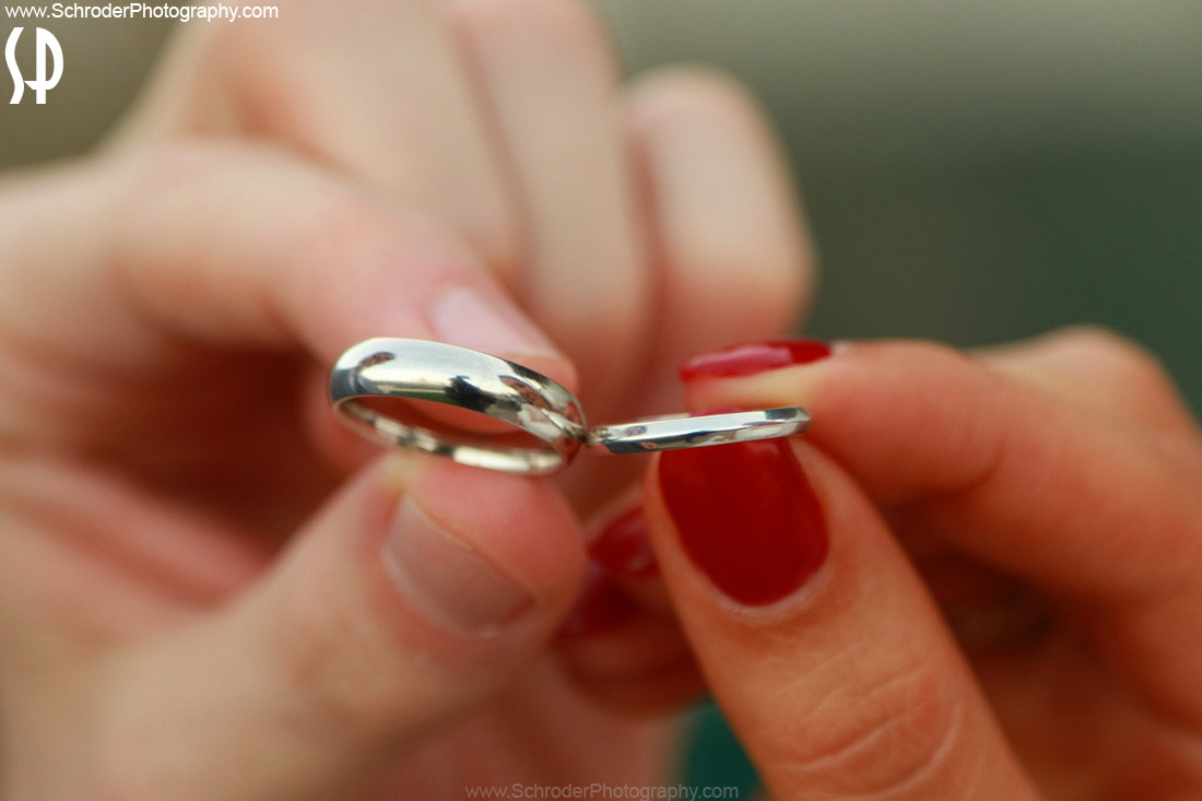 Megan and Dan hold their wedding rings
