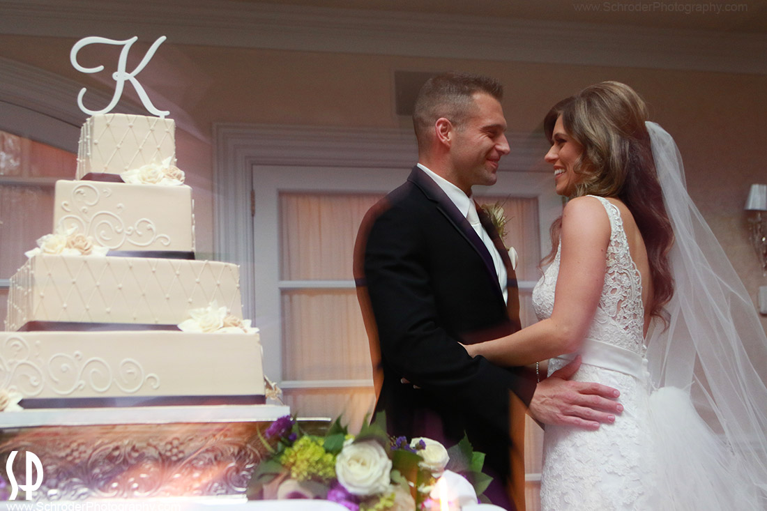 John and Amanda by their Wedding Cake.